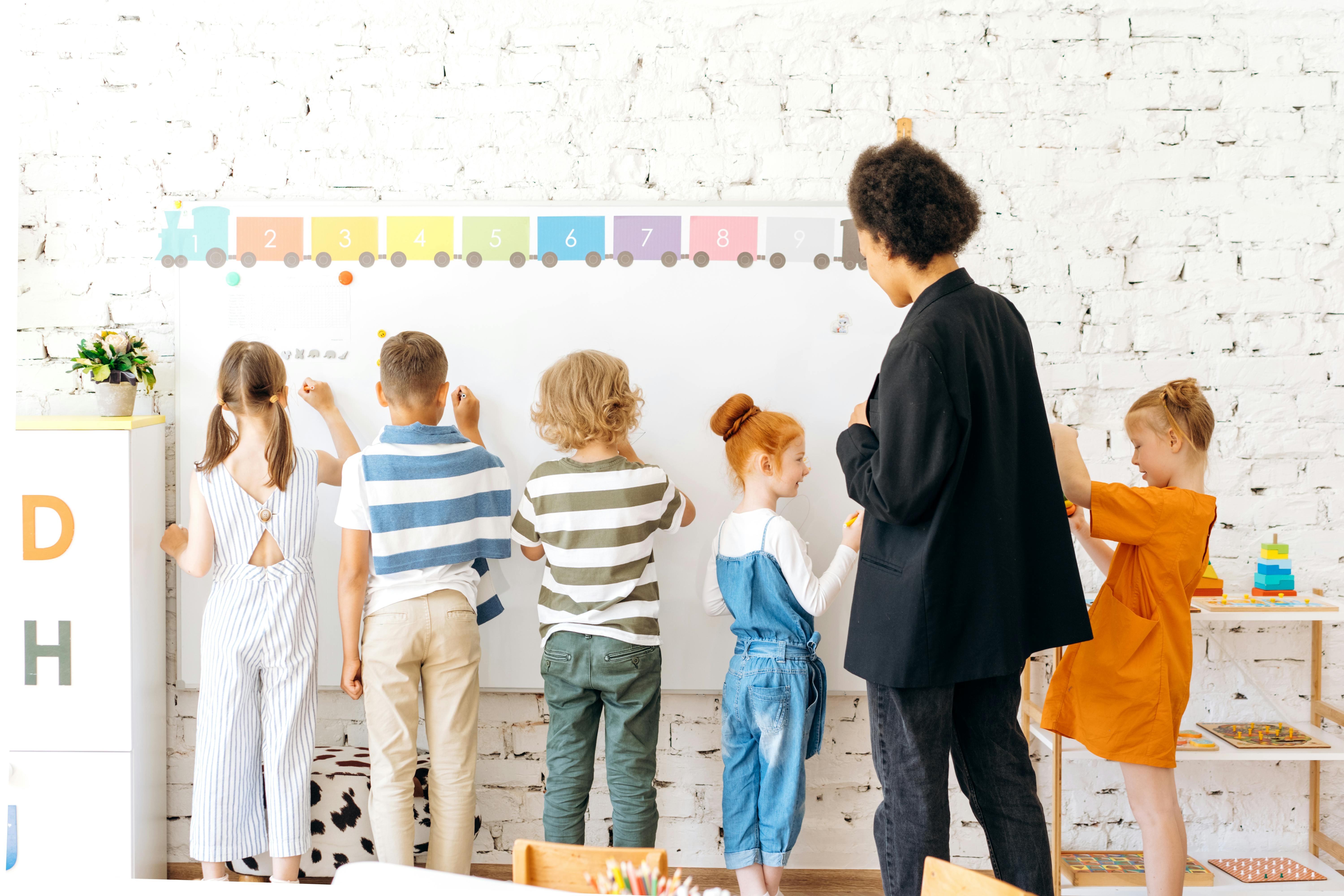 Children writing on chalkboard